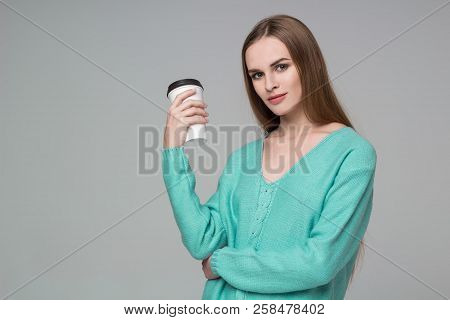 Girl In Aquamarine Jamper Drinks Coffee From Paper Plastic Glass