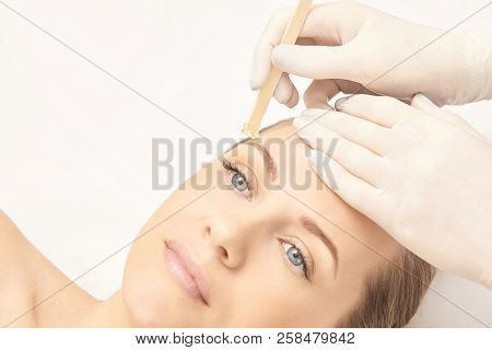 Sugar Hair Removal From Woman Body. Wax Epilation Spa Procedure. Procedure Beautician Female. Eyebro