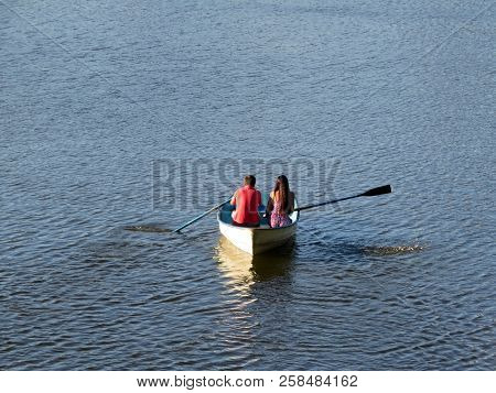 Couple In Love Sailing On A Rowing Boat. Young Man And Woman In A Boat, Romantic Date, Lost At Sea C