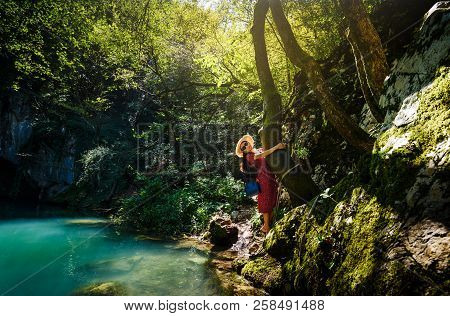 Girl Enjoying Day Outdoors At A Natural Water Well