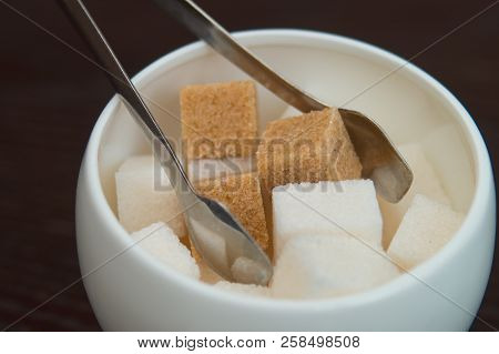 Sugar Bowl With Cubes Of White Cane Sugar And Sugar-tongs. Table Appointments In The City Cafe