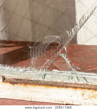 A Close Up View Of A Large Crack In A Lounge Window Where The Glass Has Chiped And Fallen Away At Th