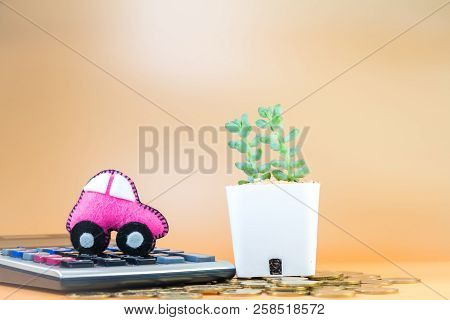 Car Model Put On The Calculator And Coin And Cactus In The Office, Loan And Saving For Buy A New Car