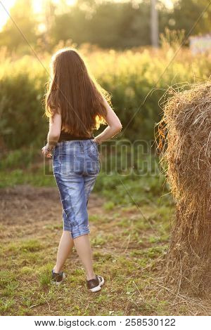 Teenager Farmer Girl With Haystack Close Up Photo On Green Summer Background
