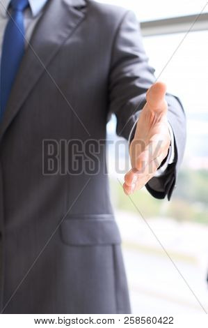 Unknown Business Man Offering Handshake While Standing Straight. Success Cooperation And Agreement C