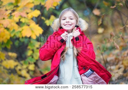 Feel So Cozy In Warm Jacket. Child Blonde Long Hair Walking In Warm Jacket Outdoor. Girl Happy In Co