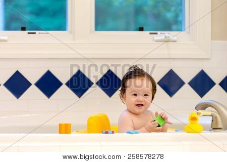 Baby Boy Taking A Bath In A Big Bath Tub