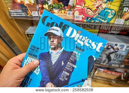 Miami, Usa - August 22, 2018: Golf Digest Magazine In A Hand Over A Stack Of Magazines. Golf Digest 