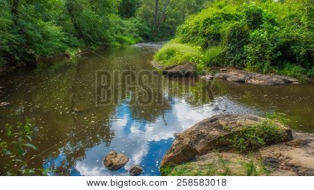 Clouds, Sky And Trrees Reflecting In The Eno River