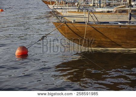 Nautical Part Of A Yacht With Cords, Rigging, Sail, Mast, Anchor, Knots On Yachts Tied Up To Buoys A