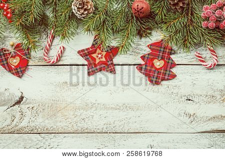 Christmas Composition With Fir Tree Branches And Red Christmas Decorations On White Wooden Backgroun