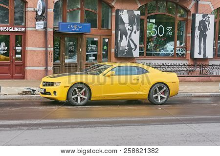 Krasnoyarsk, Russia - September 13, 2018: Chevrolet Camaro Yellow Color. The Car Is Parked Near Shop