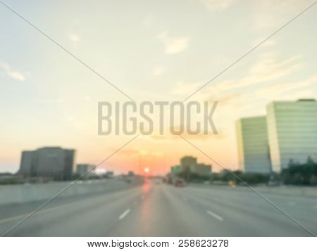 Blurry Industrial Background Highway Traffic With Downtown Skylines At Sunrise