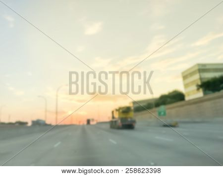 Blurry Industrial Background Highway Long Vehicles With Downtown Skylines At Sunrise