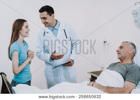 Old Man With Girl In Clinic. Old Man With Doctor In Hospital. Rehabilitation In Clinic. Girl With Do