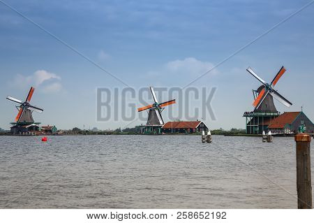 Zaanse Schans, Netherlands, August 19, 2015 - Traditional, Authentic Dutch Windmills At The River Za