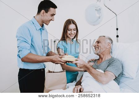 Family In Hospital With Patient. Family With Old Man In Clinic. Aged Man With Family In Clinic. Bana