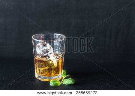 Glass Of Rum On The Dark Background