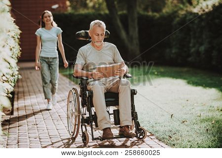 Rehabilitation With Old Man And Family. Businessman Retired In Wheelchair. Woman Help Old Man With W