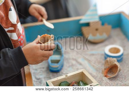 Little Autistic Boy Playing With Toy Outdoor