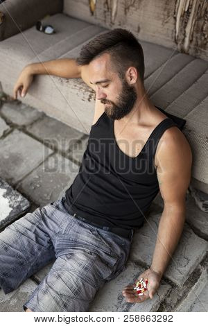 Man Lying On The Floor After A Pills Overdose And Comitting A Suicide Attampt
