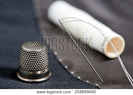 Sewing Kit On The Gray Mans Jacket