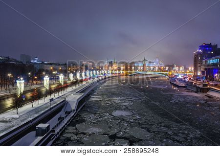 View Of Moscow Kremlin And Bolshoy Kamenny Bridge From Patriarshy Bridge At Night In Winter In Mosco