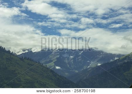 A Hills Valley With The  Snow Mountains