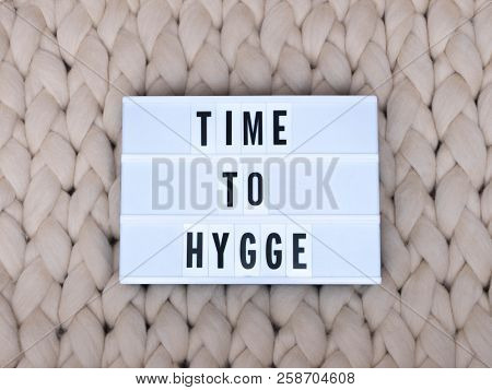 Time To Hygge Word On Lightbox On Knit Background. Cozy Compozition. Knit Background.