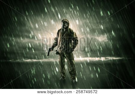 Terrorist in a stormy space with gas mask on his hand and weapons on his arm