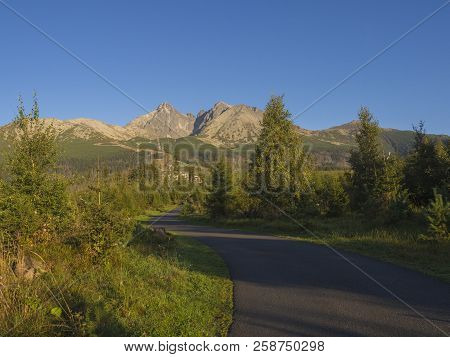 Tatra Mountains Range With Asphalt Road Curve, Golden Hour Light, Way From Tatranska Lomnice To Star