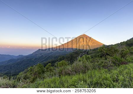 Early Morning View Of Light Hitting Mount Inerie, A Volcano In Flores, Indonesia.