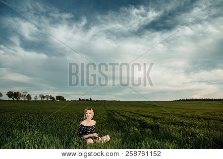 Young Girl In A Green Field. Stylish Girl. Green Grass And Blue Sky. Emotional Woman. Plener. Travel