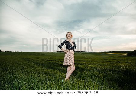Young Girl In A Green Field. Stylish Girl. Green Grass And Blue Sky. Emotional Woman. Plener. Travel