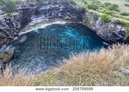 View Looking Down At The Beautiful Blue Lagoon At Broken Beach In Nusa Penida, Indonesia.