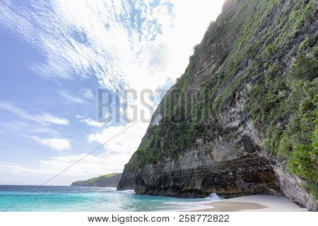 A Cliff Face And Part Of Kelingking Beach On Nusa Penida In Indonesia.