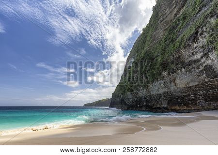 Clouds, Blue Sky And Tropical Surf At Kelingking Beach On Nusa Penida In Indonesia.