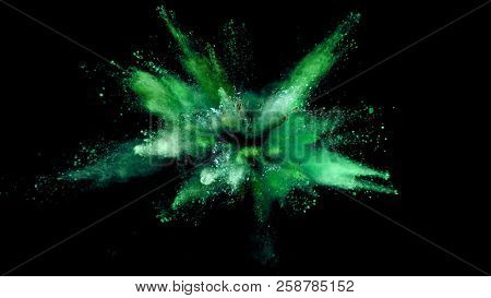 Explosion of coloured powder isolated on black background. Abstract colored background