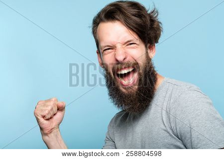 Victory Success And Achievement. Happy Joyful Laughing Guy Making A Win Gesture. Excited Thrilled Ag