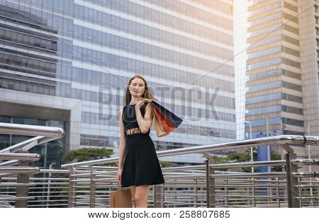 Portrait Of Beautiful Woman Smling And Holding Shopping Bags In City,lifestyle Concept