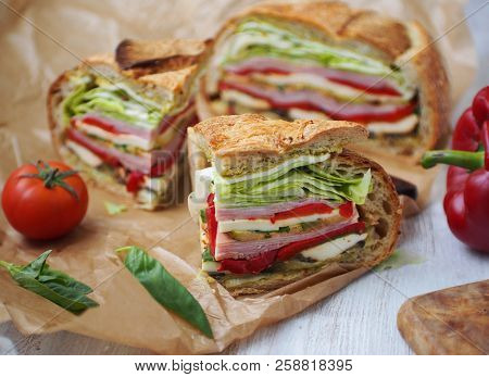 Mediterranean Pressed Picnic Sandwich With Mozarella, Grilled Vegetables And Ham