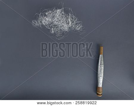Silver Thread Pile Like Cloud And Spool Of Silver Thread. Pile Of Silver Thread On Grey Background.