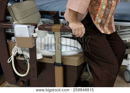 Old Woman Use Portable Mobile Plastic Toilet Near  Patient Bed