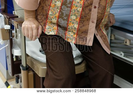 Old Woman Use Portable Mobile Plastic Toilet Near  Patient Bed