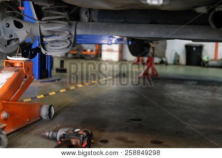Car Lift Up For Shock Absorber & Spring Replacement In Auto Repair Garage
