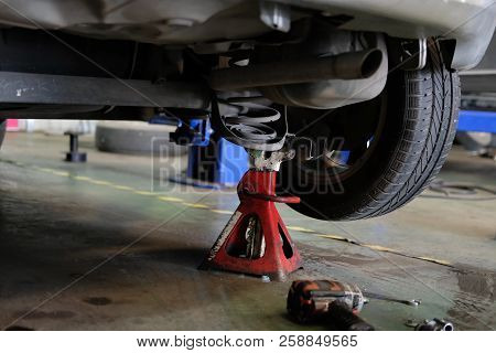 Car Lift Up For Shock Absorber & Spring Replacement In Auto Service Repair Garage