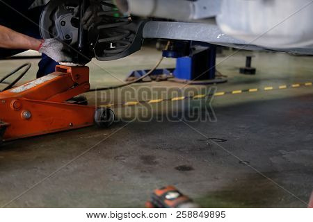 Mechanic Replace Shock Absorber & Spring In Auto Service Repair Garage