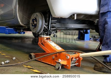 Car Lift Up For Shock Absorber & Spring Replacement In Auto Repair Garage