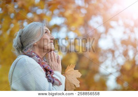 Happy Beautifil Elderly Woman Posing In Autumn Park