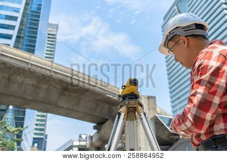 Civil Engineer Land Survey With Tacheometer Or Theodolite Equipment. Worker Checking Construction Si